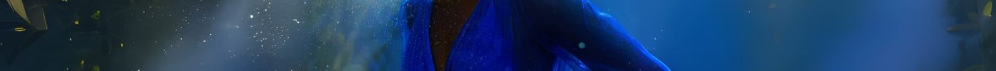 Beautiful dark skinned woman in cobalt blue dress smiling in forest setting