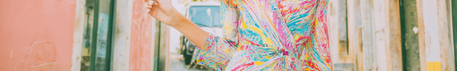 Woman in colorful dress standing in alleyway