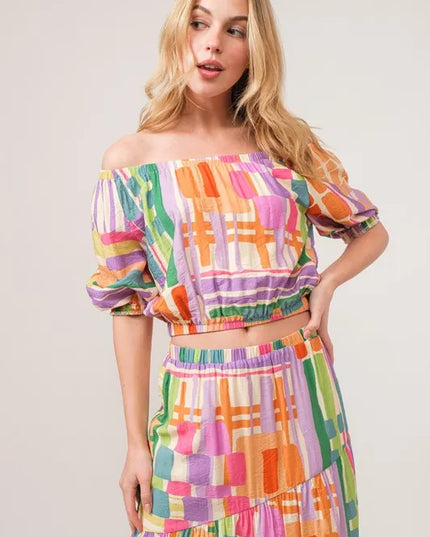 Woman wearing a colorful checkered matching set against a plain background