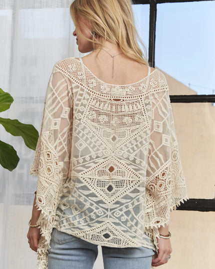 Woman wearing a Boho Mirage Crochet Lace Cover-Up with a blurred background