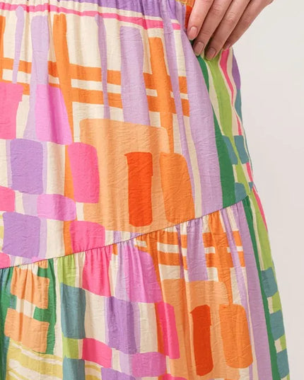 Colorful geometric patterned skirt with a white background