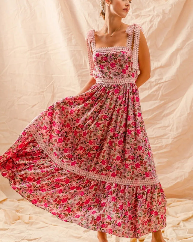 Woman wearing a Wild Bloom Smocked Maxi Dress against a beige background