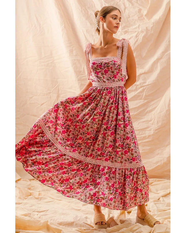 Woman wearing a Wild Bloom Smocked Maxi Dress against a beige background