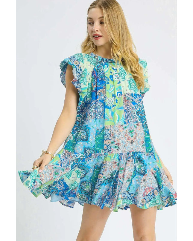 Woman wearing a colorful patterned dress on a white background