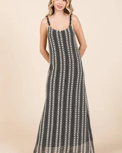 Woman wearing a black and white patterned dress on a beige background