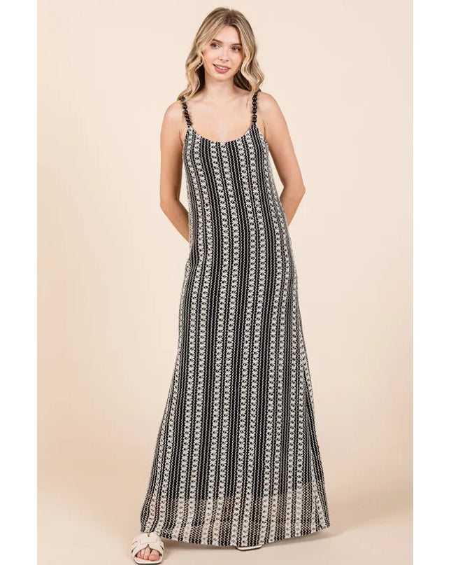 Woman wearing a black and white patterned dress on a beige background
