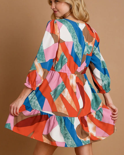 Woman wearing a colorful patterned dress on a beige background