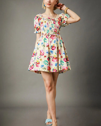 Woman wearing a floral dress against a gray background