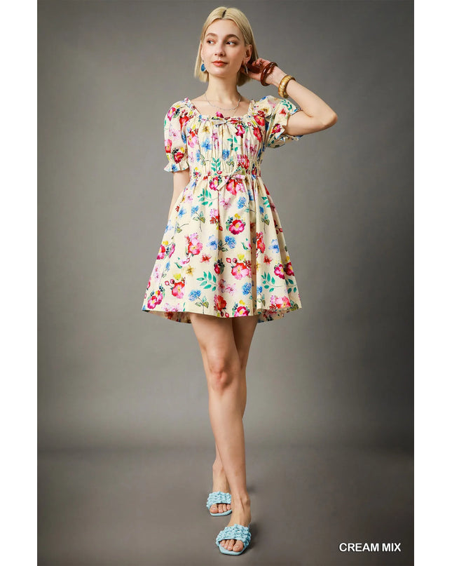 Woman wearing a floral dress against a gray background