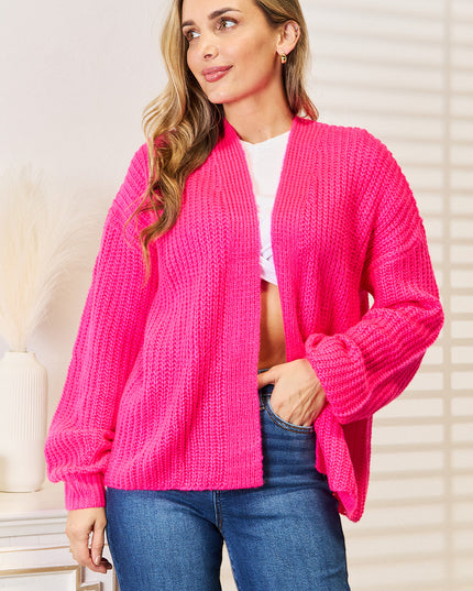 Woman in hot pink ribbed cardigan 