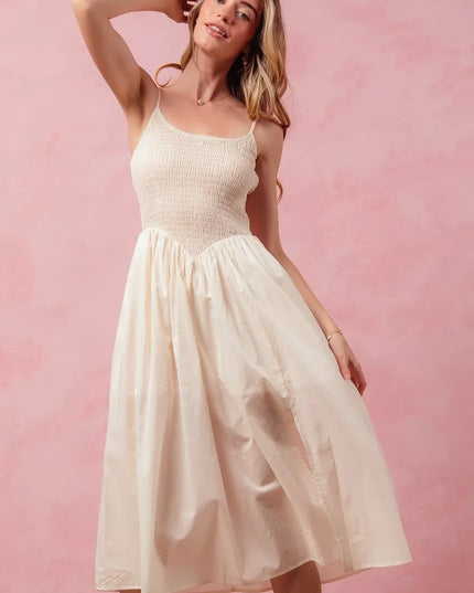 Woman wearing a white dress against a pink background