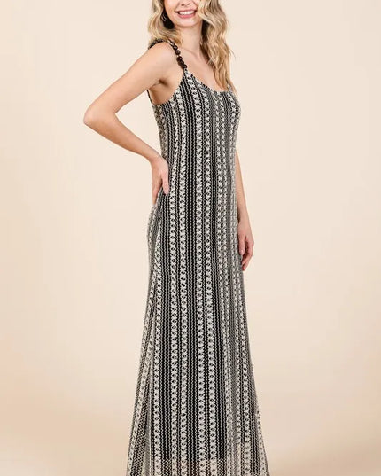 Woman wearing a black and white patterned dress on a beige background