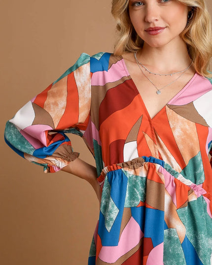 Woman wearing a colorful patterned dress against a brown background