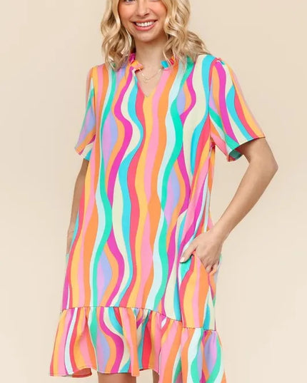 Woman wearing a colorful striped dress on a beige background