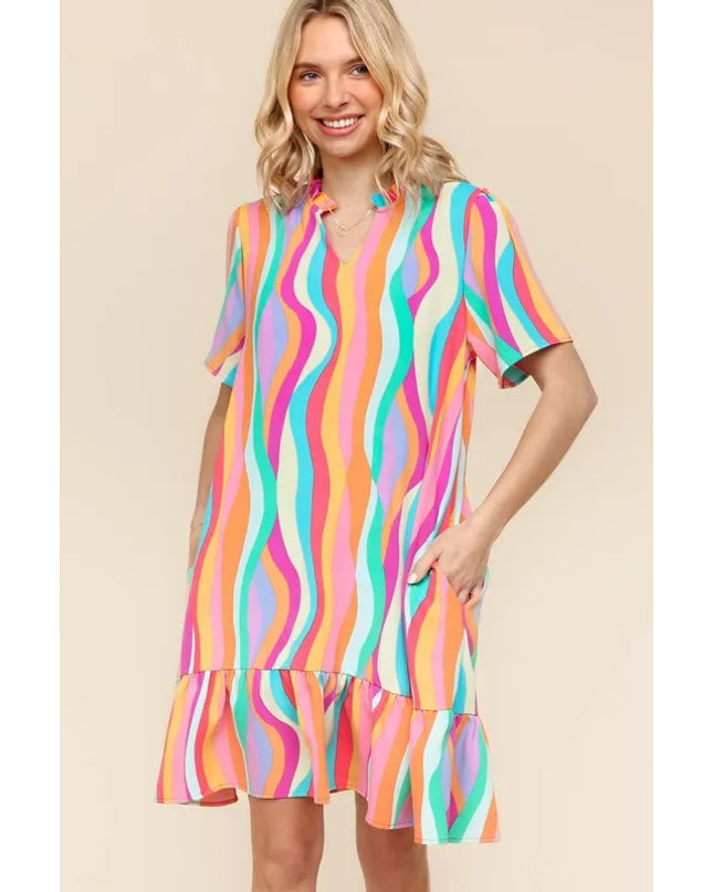 Woman wearing a colorful striped dress on a beige background