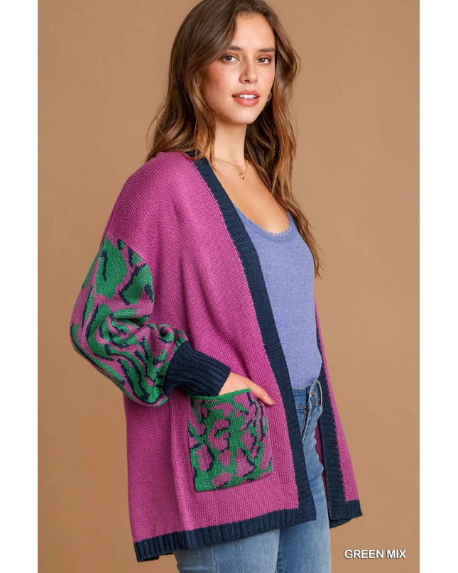 Woman wearing a purple cardigan with green patterns on a beige background