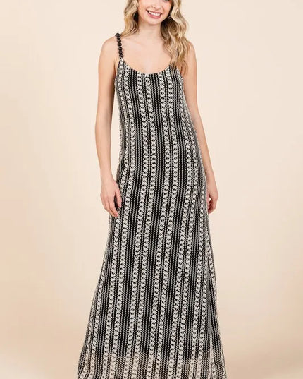 Woman wearing a black and white patterned dress on a beige background