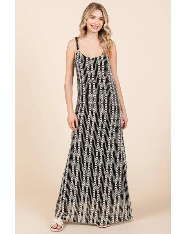 Woman wearing a black and white patterned dress on a beige background