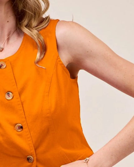 Orange vest with brown buttons on a plain background