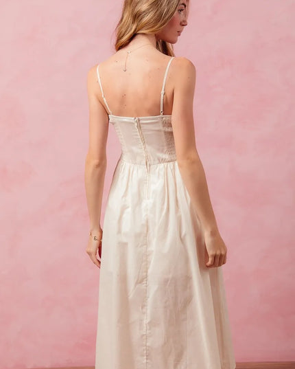 Woman wearing a white dress against a pink background