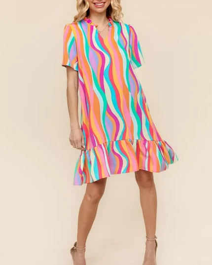Woman wearing a colorful striped dress on a beige background