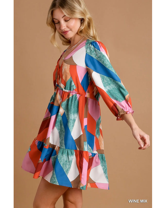 Woman wearing a colorful patterned dress on a beige background