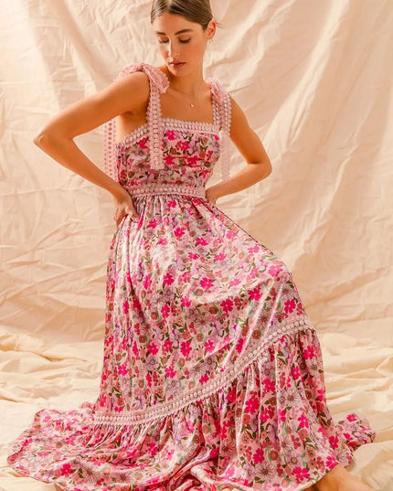 Woman wearing a Wild Bloom Smocked Maxi Dress against a beige background