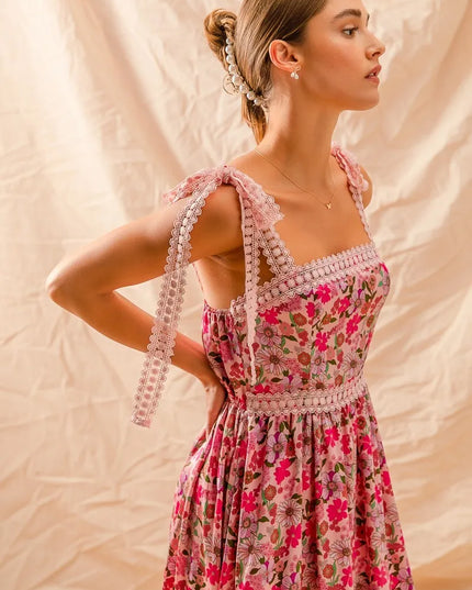 Woman wearing a Wild Bloom Smocked Maxi Dress with beaded straps against a beige background