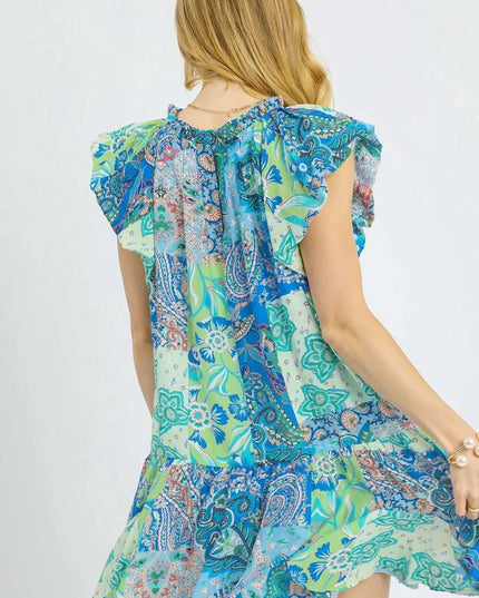 Woman wearing a colorful patterned dress on a white background