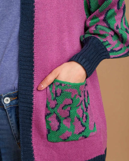 Close-up of a pink and green patterned sweater with a pocket.