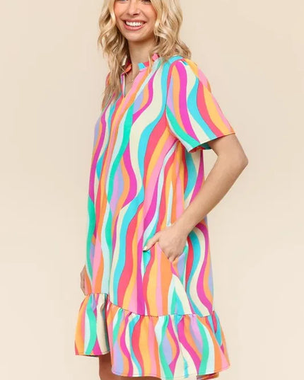Woman wearing a colorful striped dress on a beige background