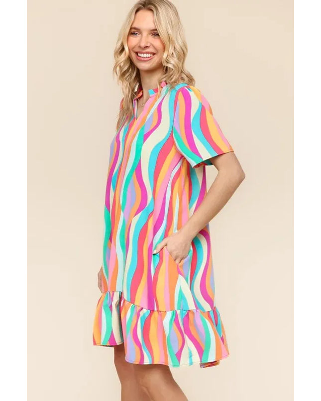 Woman wearing a colorful striped dress on a beige background