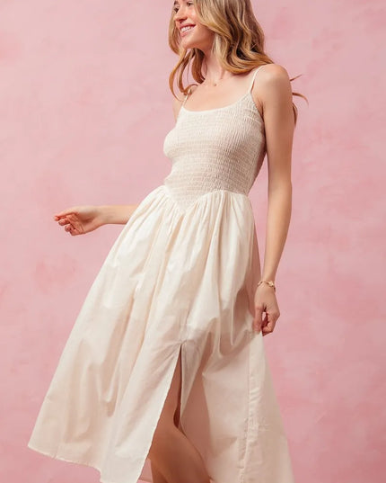 Woman wearing a white dress against a pink background