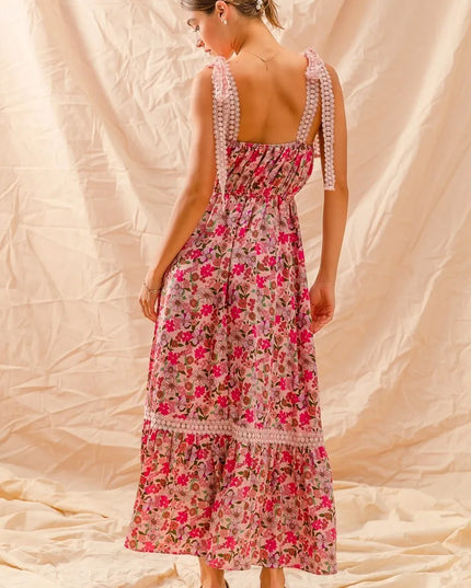 Woman wearing a Wild Bloom Smocked Maxi Dress with a plain background