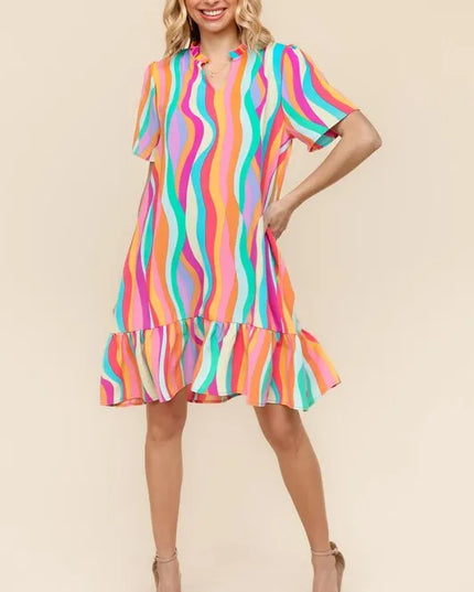 Woman wearing a colorful striped dress on a beige background