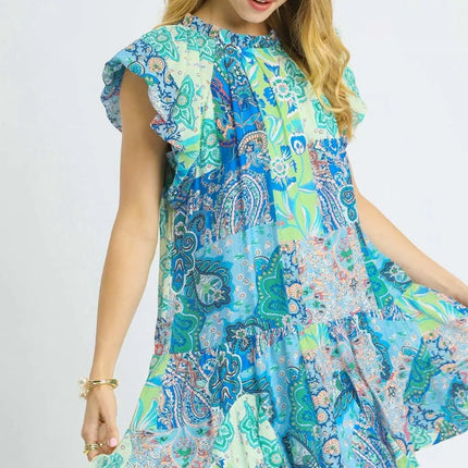 Woman wearing a colorful patterned dress on a white background