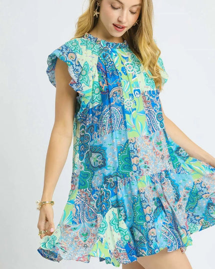 Woman wearing a colorful patterned dress on a white background