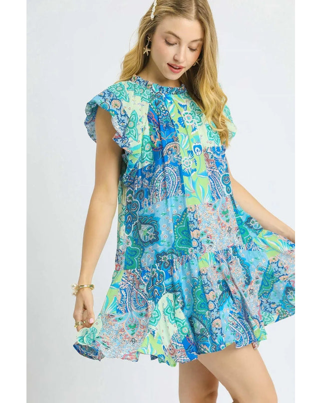 Woman wearing a colorful patterned dress on a white background