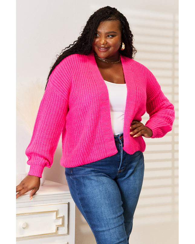 Woman in hot pink ribbed cardigan 
