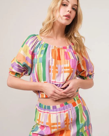 Woman wearing a colorful checkered matching set against a plain background