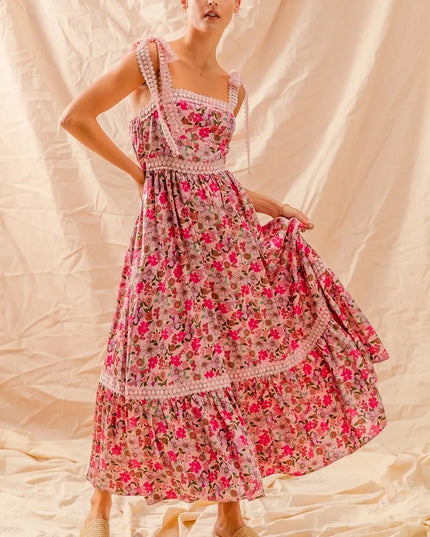 Woman wearing a Wild Bloom Smocked Maxi Dress against a beige background