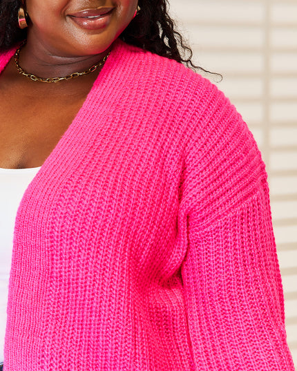 Woman in hot pink ribbed cardigan 