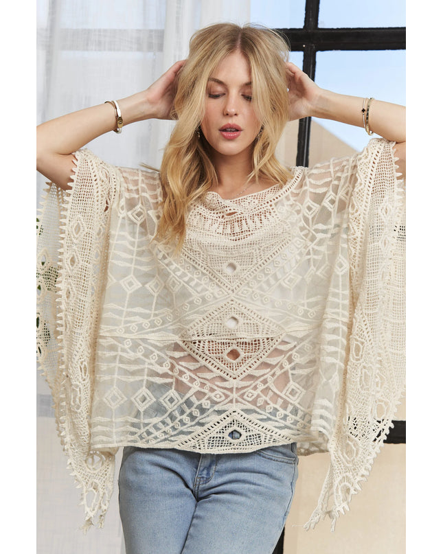 Woman wearing a Boho Mirage Crochet Lace Cover-Up with a blurred indoor background